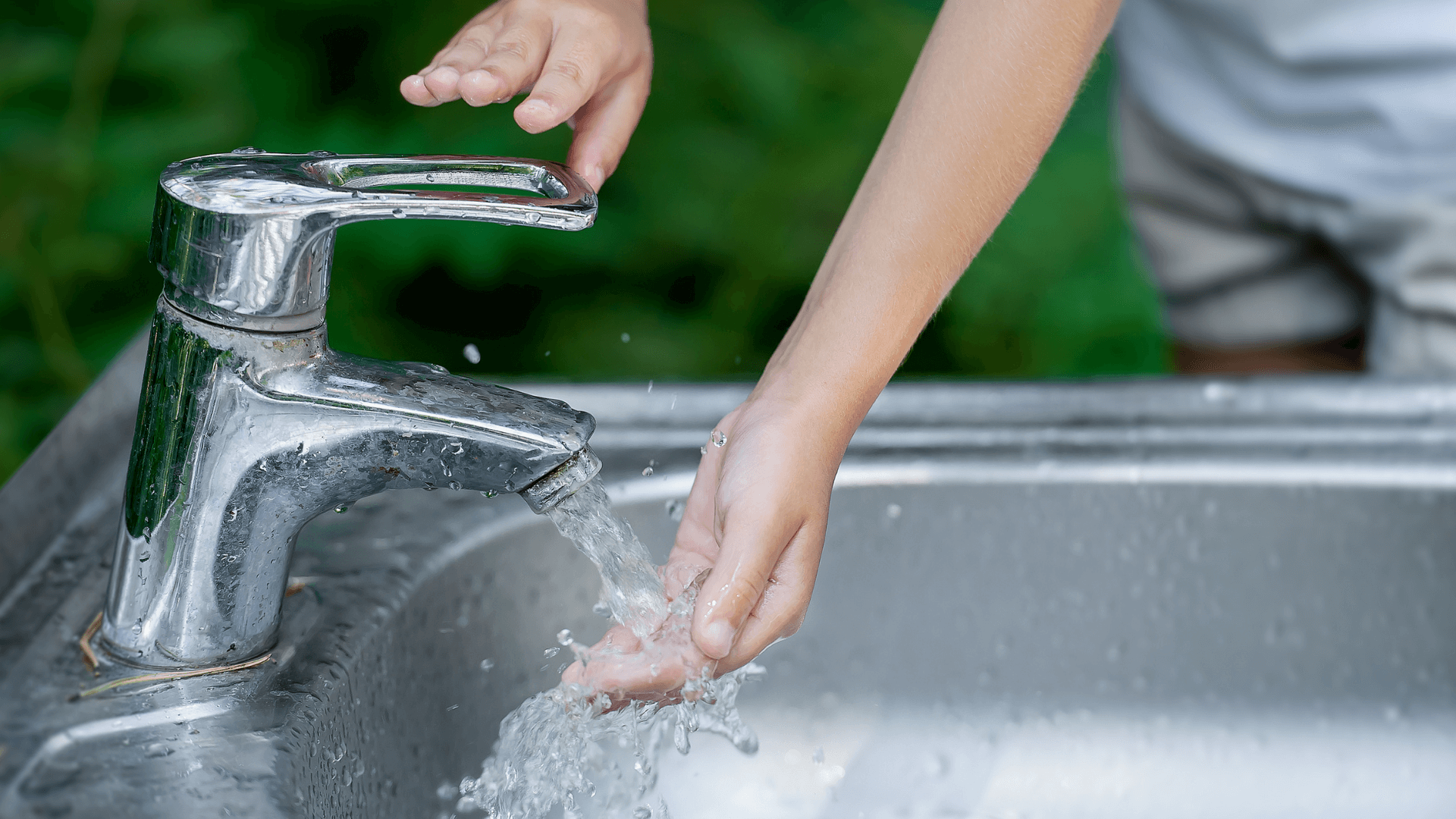 Hand on Kitchen Tap