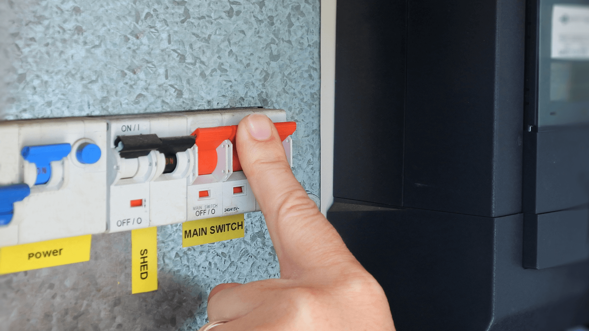 Electricity switchboard with finger on a switch