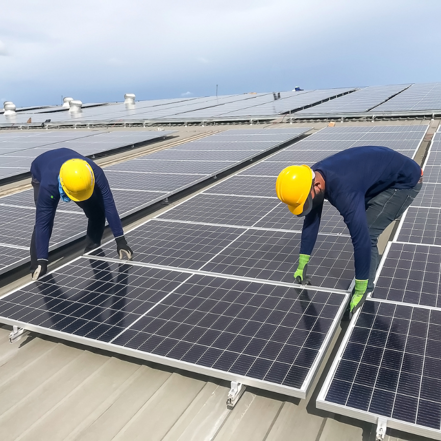 Two workers repairing solar panel