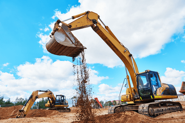 Excavation diggers lifting dirt at construction site
