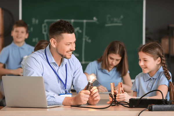 Teacher teaching student about electricity