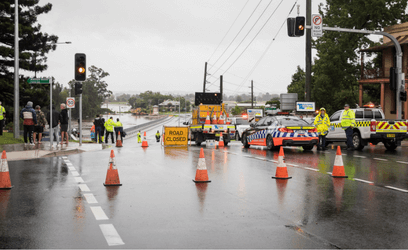 Emergency services responding to flood with road closed