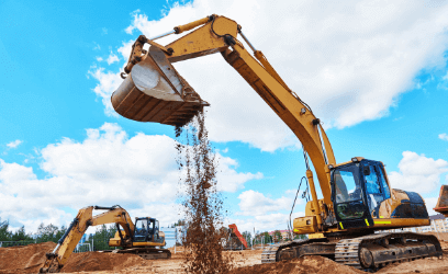 Two excavation digging machines lifting dirt at construction site