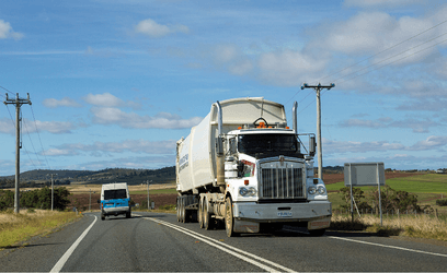 Truck driving past poles